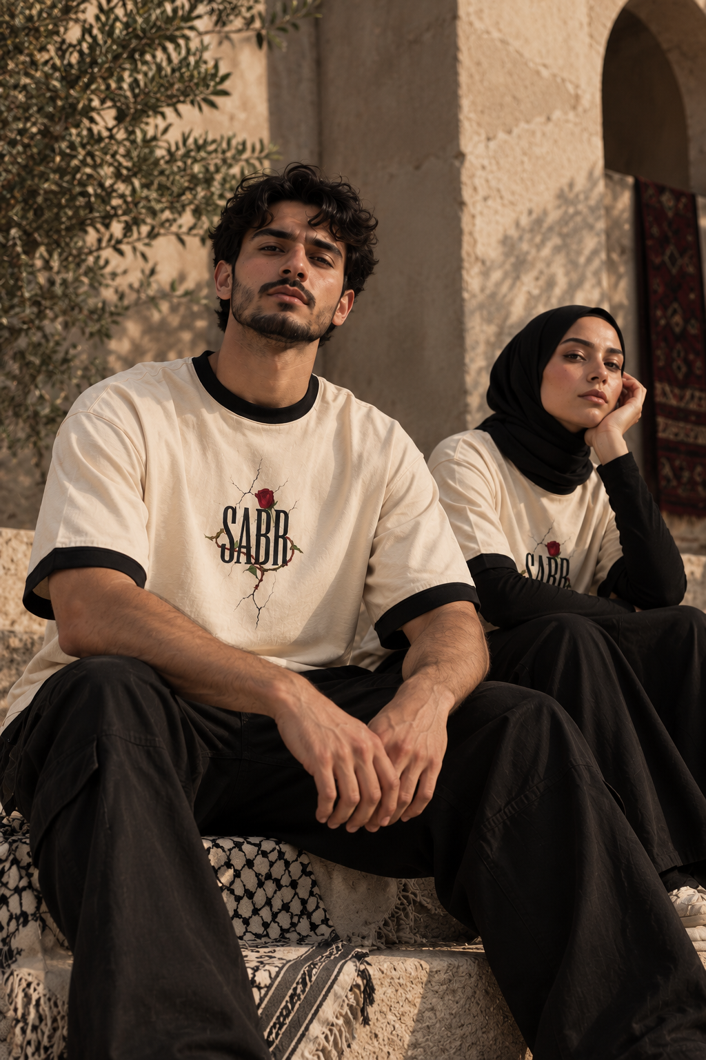 Two-model editorial portrait featuring WAQT SABR rose T-shirt